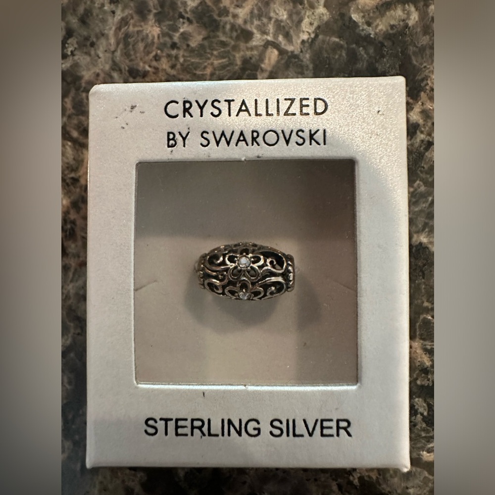 Beautiful sterling silver dead with tiny flower motif and light blue stone.